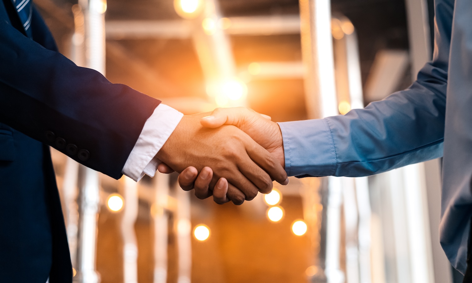 Business shaking hands, finishing up meeting. Successful businessmen handshaking after good deal.