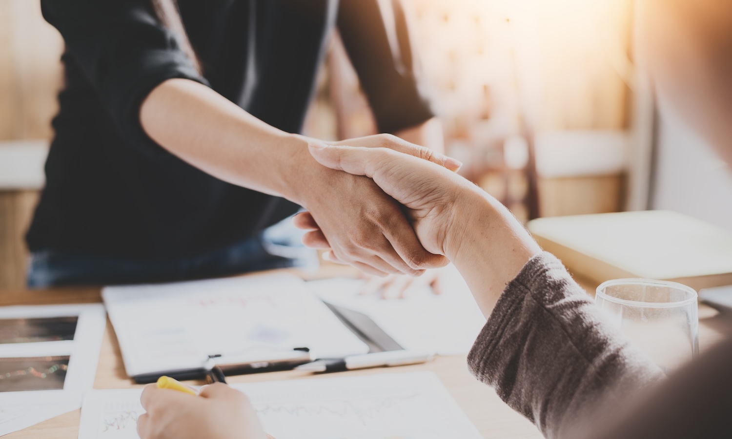 Negotiating business,Image of businesswomen Handshaking,happy with work,the woman she is enjoying with her workmate,Handshake Gesturing People Connection Deal Concept